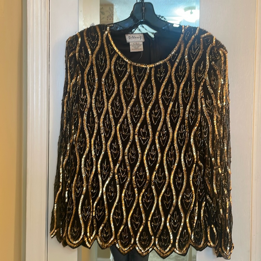 Beautiful shiny sequined blouse. 100% silk and polyester
